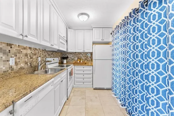 a bathroom with a granite countertop sink toilet a mirror and shower