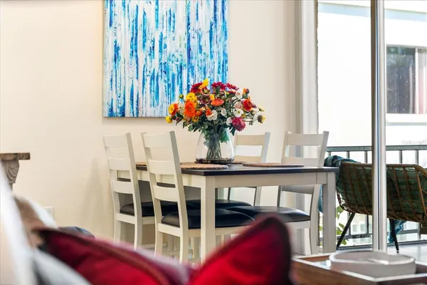a living room with furniture and a painting on the wall