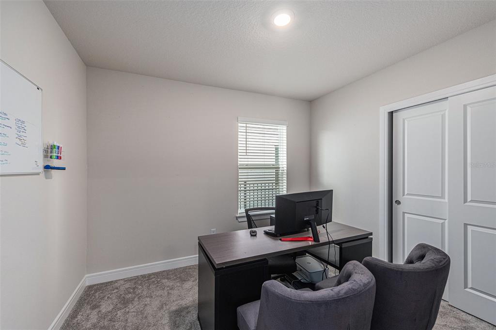 8312 Reefbay Cove Parrish, FL 34221 - Photo 14 of 36 a living room with furniture and a window