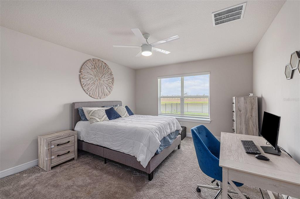 8312 Reefbay Cove Parrish, FL 34221 - Photo 15 of 36 a bedroom with a bed and a desk