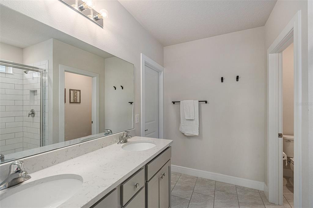 8312 Reefbay Cove Parrish, FL 34221 - Photo 17 of 36 a bathroom with a sink double vanity and a mirror