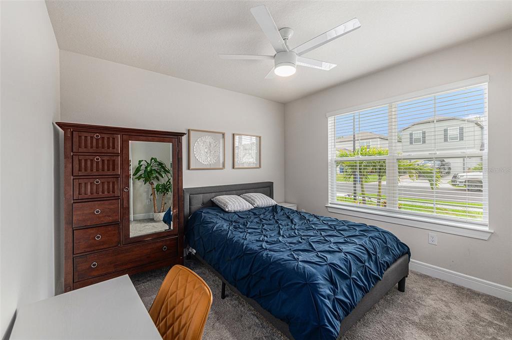 8312 Reefbay Cove Parrish, FL 34221 - Photo 19 of 36 a bedroom with a bed and a potted plant