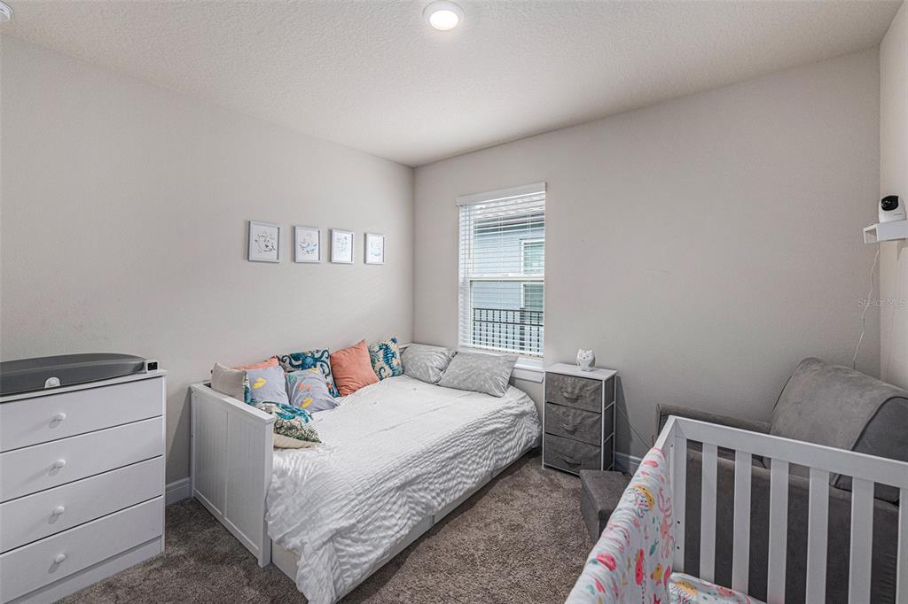 8312 Reefbay Cove Parrish, FL 34221 - Photo 20 of 36 a bedroom with a bed and window