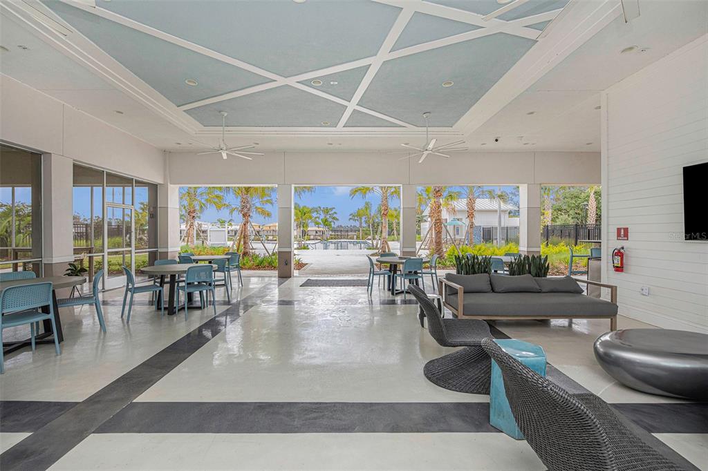 8312 Reefbay Cove Parrish, FL 34221 - Photo 29 of 36 a living room with furniture and a dining table with wooden floor