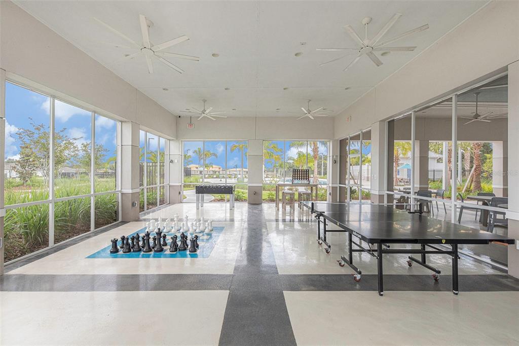 8312 Reefbay Cove Parrish, FL 34221 - Photo 30 of 36 a living room with furniture and large windows