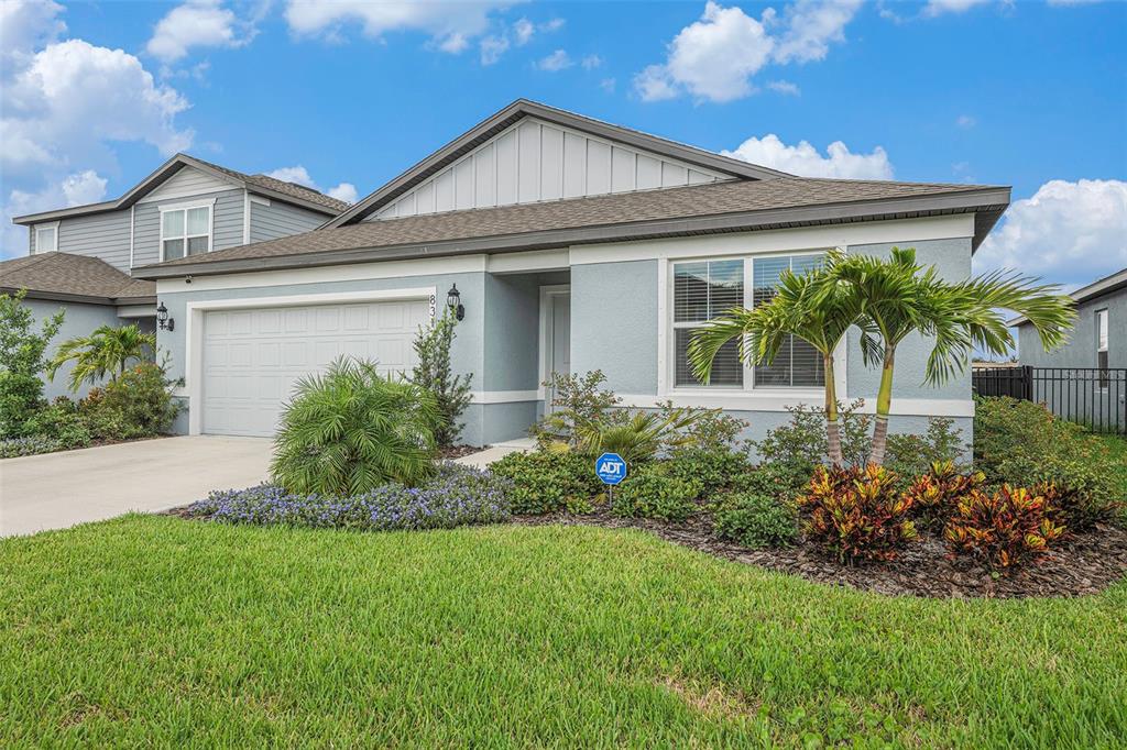 8312 Reefbay Cove Parrish, FL 34221 - Photo 3 of 36 a front view of a house with garden