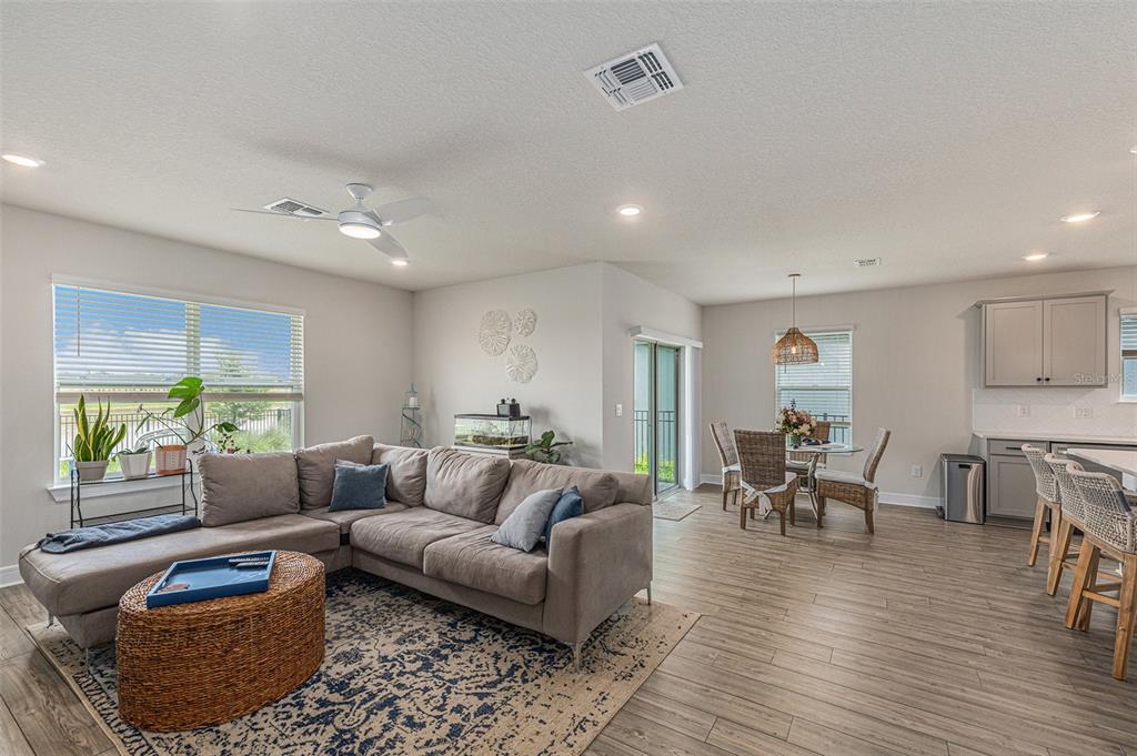 8312 Reefbay Cove Parrish, FL 34221 - Photo 5 of 36 a living room with furniture and a wooden floor