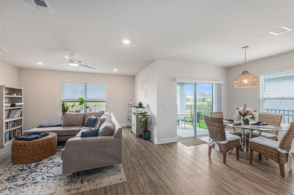 8312 Reefbay Cove Parrish, FL 34221 - Photo 6 of 36 a living room with furniture and wooden floor