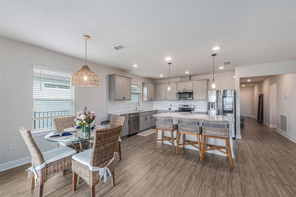8312 Reefbay Cove Parrish, FL 34221 - Photo 7 of 36 a view of a dining room with furniture window and wooden floor