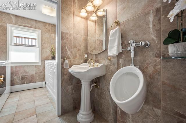 8475 Red Spring Valley Road Colorado Springs, CO 80919 - Photo 31 of 50 Main level half bathroom with both toilet and urinal.