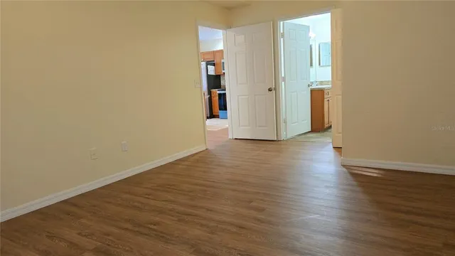 a view of a room with wooden floor and brick walls