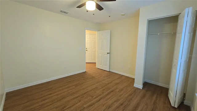 a view of an empty room with wooden floor
