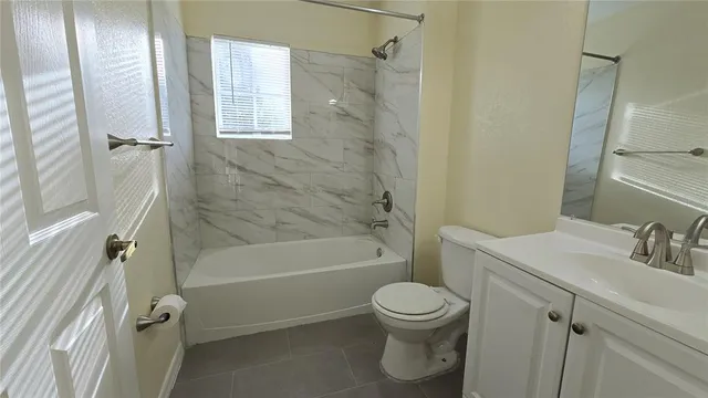 a bathroom with a toilet sink and shower
