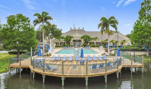 a view of a lake with a house swimming pool and outdoor space