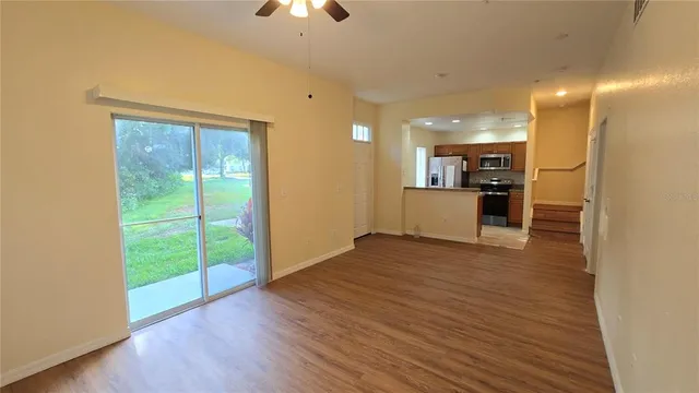 a view of a kitchen with a sink and a refrigerator