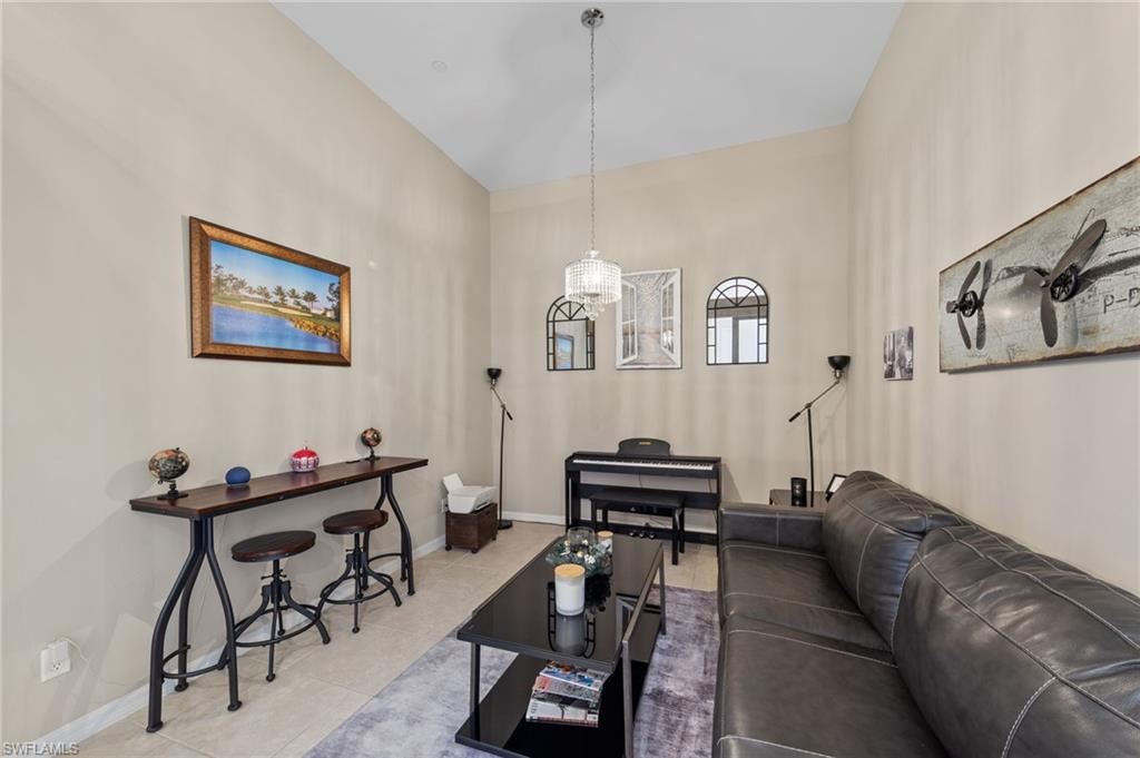 9366 Pocida Court, Unit 202 Naples, FL 34119 - Photo 15 of 44 a living room with furniture and a piano