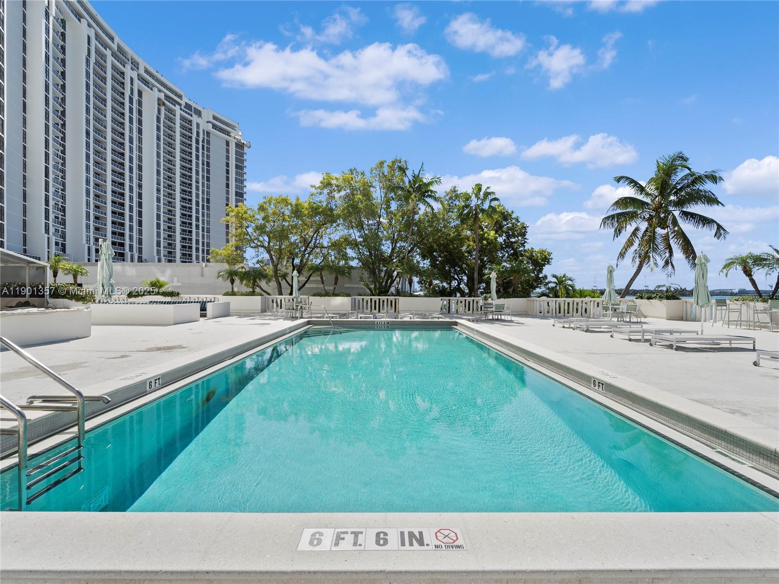 5 Island Avenue, Unit LE Miami Beach, FL 33139 - Photo 26 of 30 a swimming pool with outdoor seating and yard in back