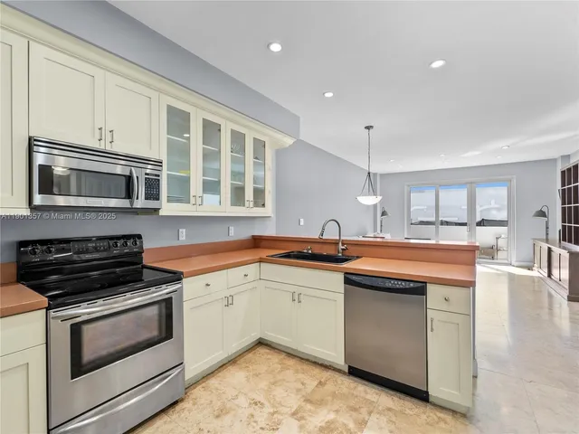 a kitchen with stainless steel appliances granite countertop a stove and a sink