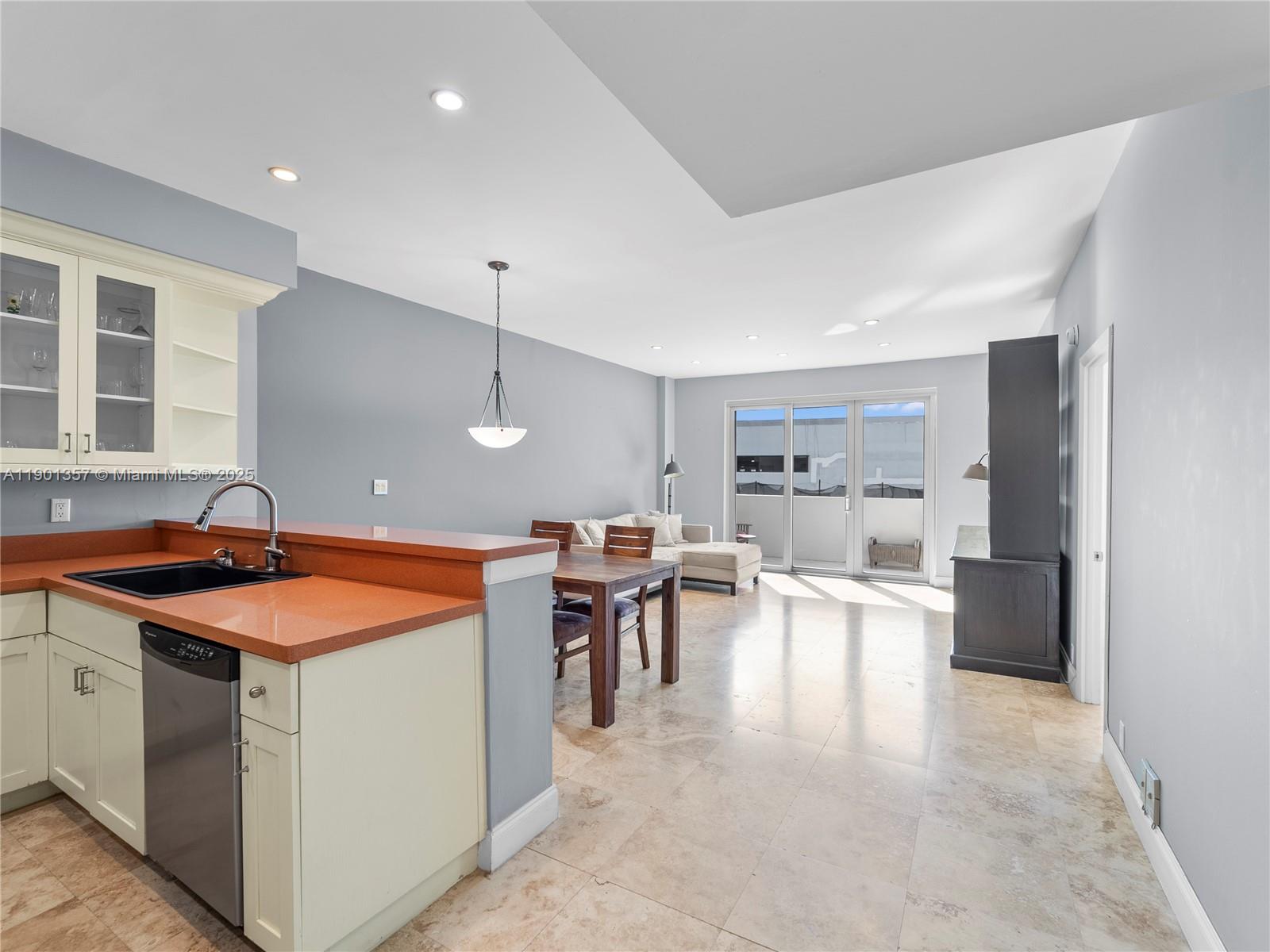 5 Island Avenue, Unit LE Miami Beach, FL 33139 - Photo 5 of 30 a kitchen with a sink a stove a refrigerator and chairs