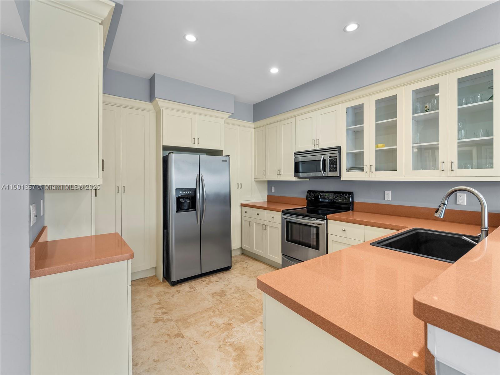 5 Island Avenue, Unit LE Miami Beach, FL 33139 - Photo 6 of 30 a kitchen with stainless steel appliances granite countertop a refrigerator stove and sink