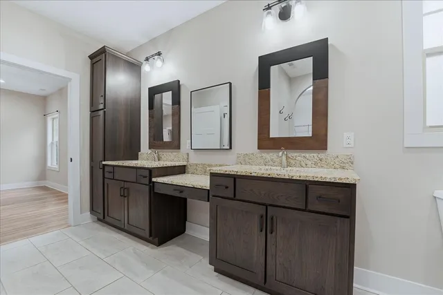 a bathroom with a granite countertop sink and a mirror