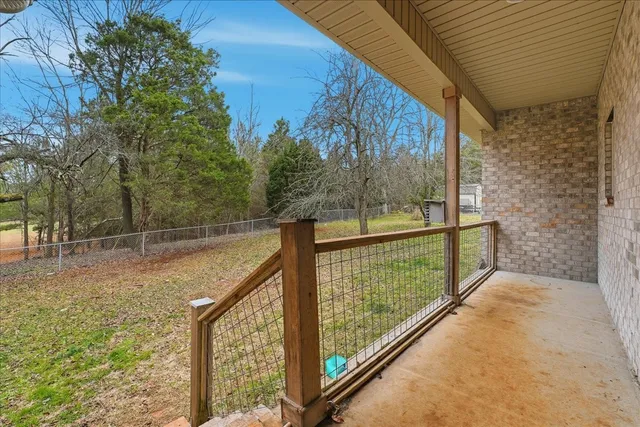 a view of a balcony with yard