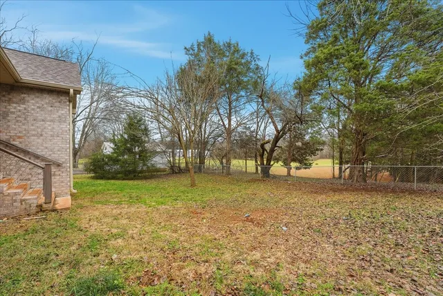 a backyard of a house with lots of green space