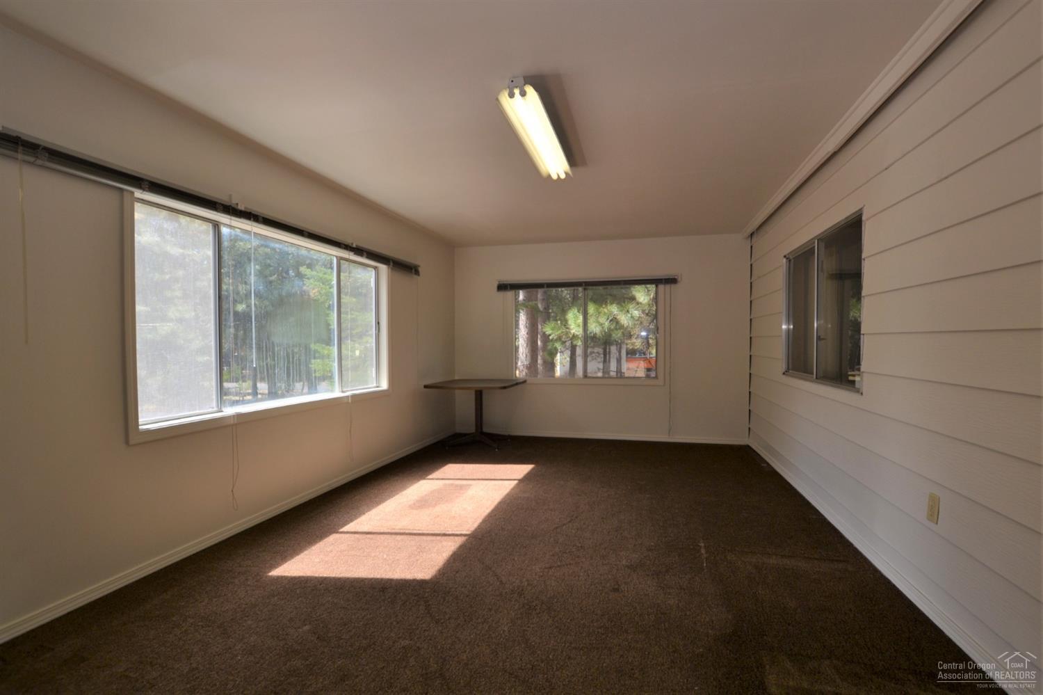 60176 Agate Road Bend, OR 97702 - Photo 4 of 21 a view of an empty room with a window