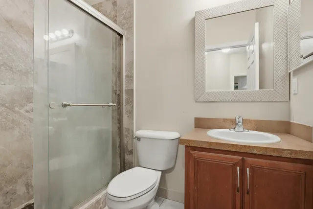 a bathroom with a sink toilet and shower