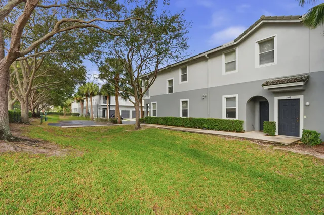 a front view of house with yard and green space