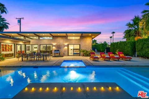 a view of a swimming pool with an outdoor seating