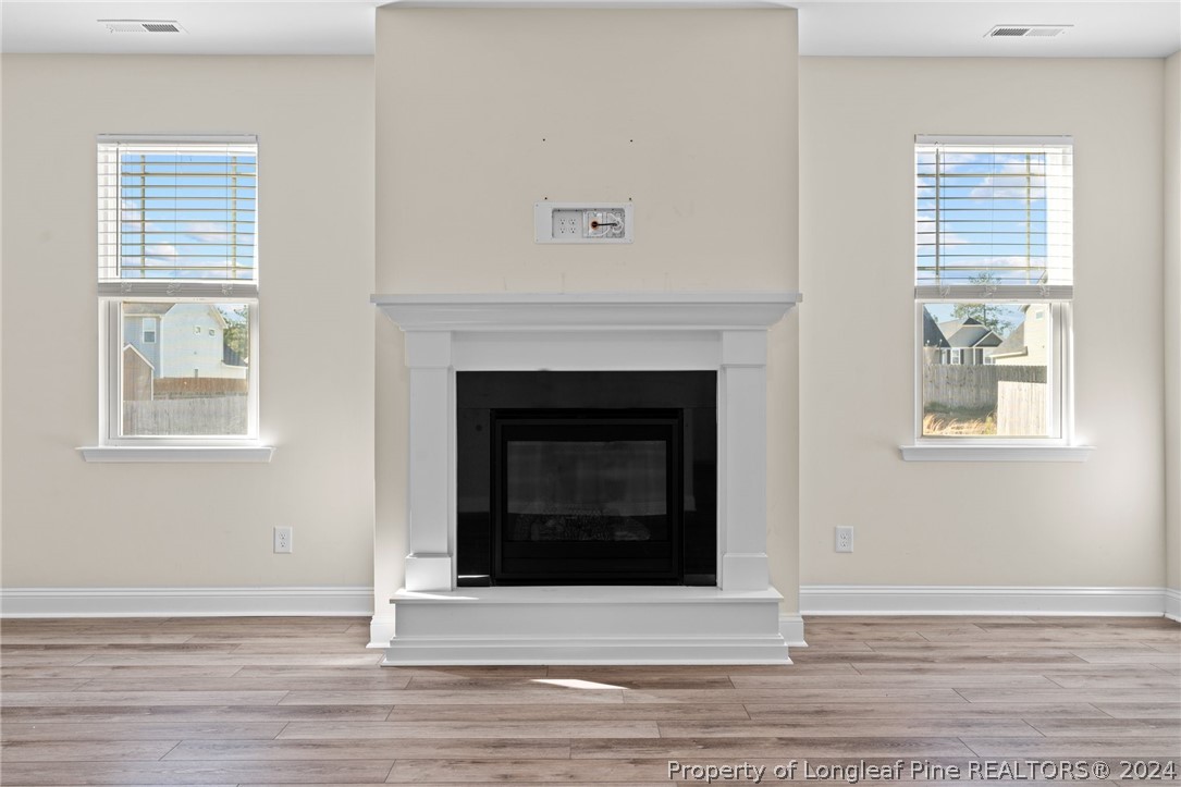 560 Angel Oak Drive Bunnlevel, NC 28323 - Photo 15 of 49 a living room with a fireplace and a window