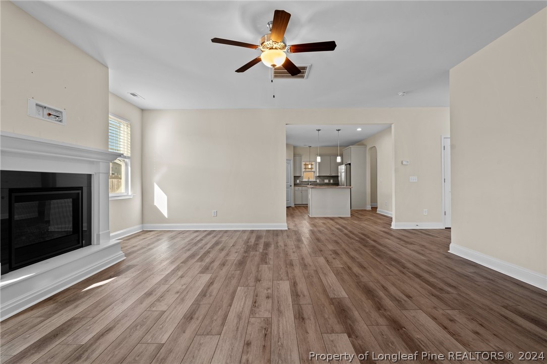 560 Angel Oak Drive Bunnlevel, NC 28323 - Photo 16 of 49 a view of empty room with wooden floor and a fireplace