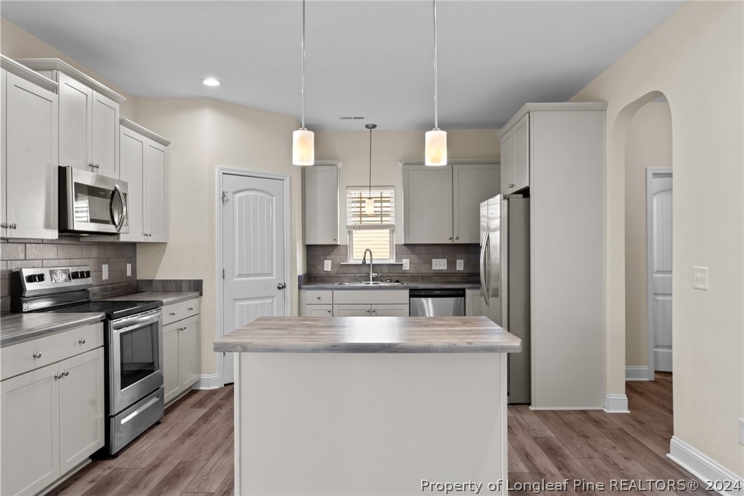 560 Angel Oak Drive Bunnlevel, NC 28323 - Photo 18 of 49 a kitchen with stainless steel appliances granite countertop a refrigerator stove microwave and sink