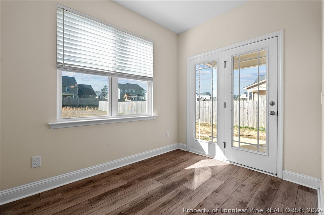 560 Angel Oak Drive Bunnlevel, NC 28323 - Photo 24 of 49 a view of an empty room with wooden floor and a window