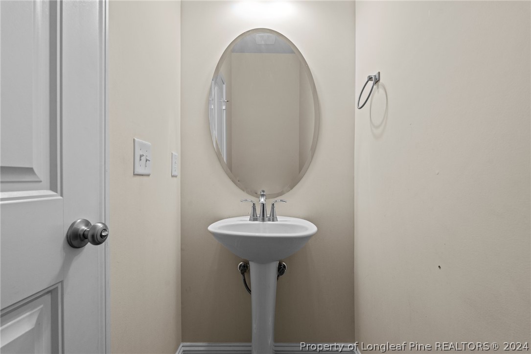 560 Angel Oak Drive Bunnlevel, NC 28323 - Photo 26 of 49 a bathroom with a sink and a mirror