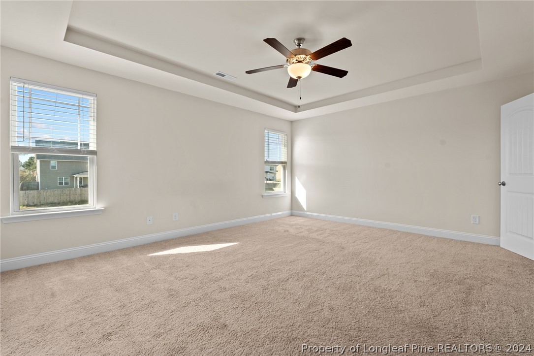 560 Angel Oak Drive Bunnlevel, NC 28323 - Photo 29 of 49 en empty room with windows and ceiling fan