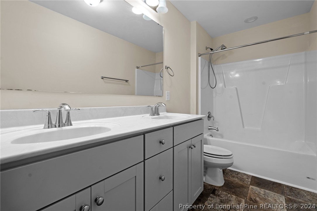 560 Angel Oak Drive Bunnlevel, NC 28323 - Photo 36 of 49 a spacious bathroom with a double vanity sink toilet mirror and shower