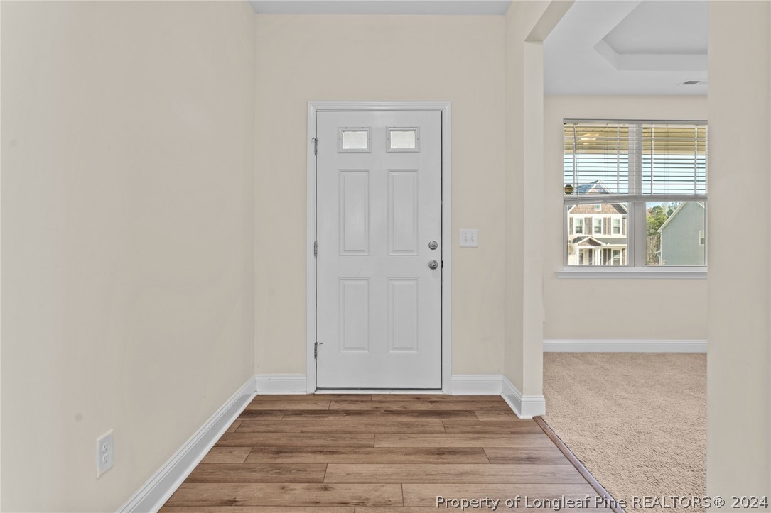 560 Angel Oak Drive Bunnlevel, NC 28323 - Photo 10 of 49 a view of an empty room with wooden floor and a window