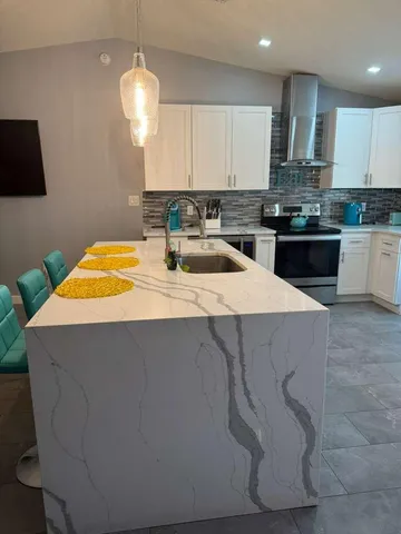 a kitchen with a sink cabinets and appliances