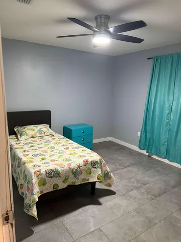 a bed sitting in a bedroom next to a cabinet