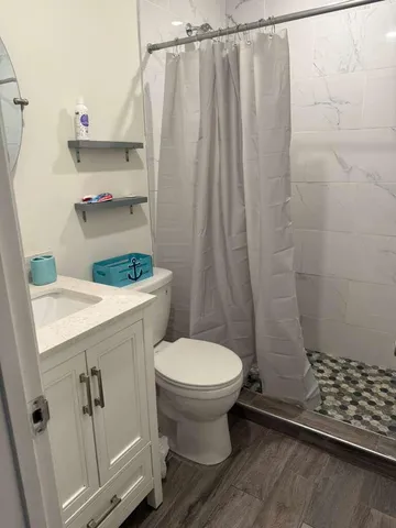 a bathroom with a sink toilet and shower
