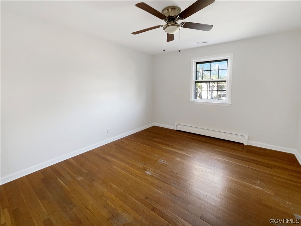 1303 Covington Road Colonial Heights, VA 23834 - Photo 11 of 15 an empty room with wooden floor and windows