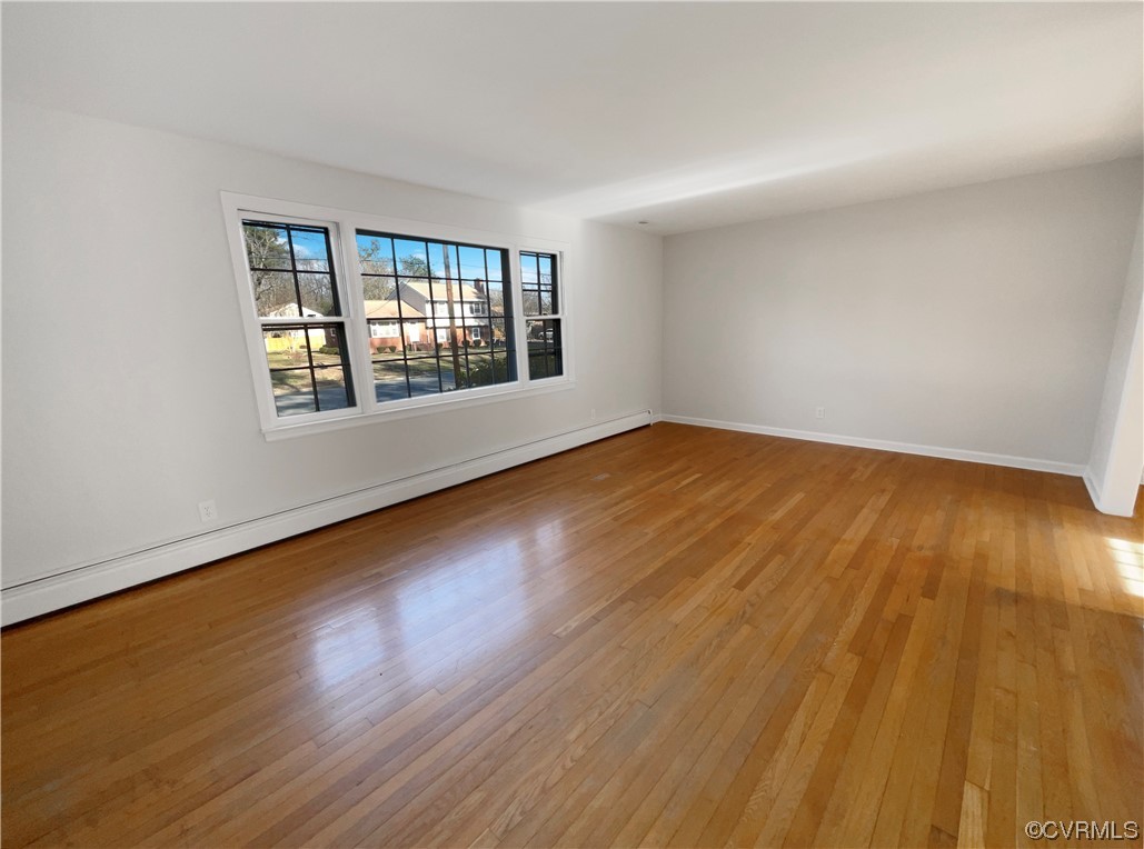 1303 Covington Road Colonial Heights, VA 23834 - Photo 7 of 15 a view of an empty room with wooden floor and a window