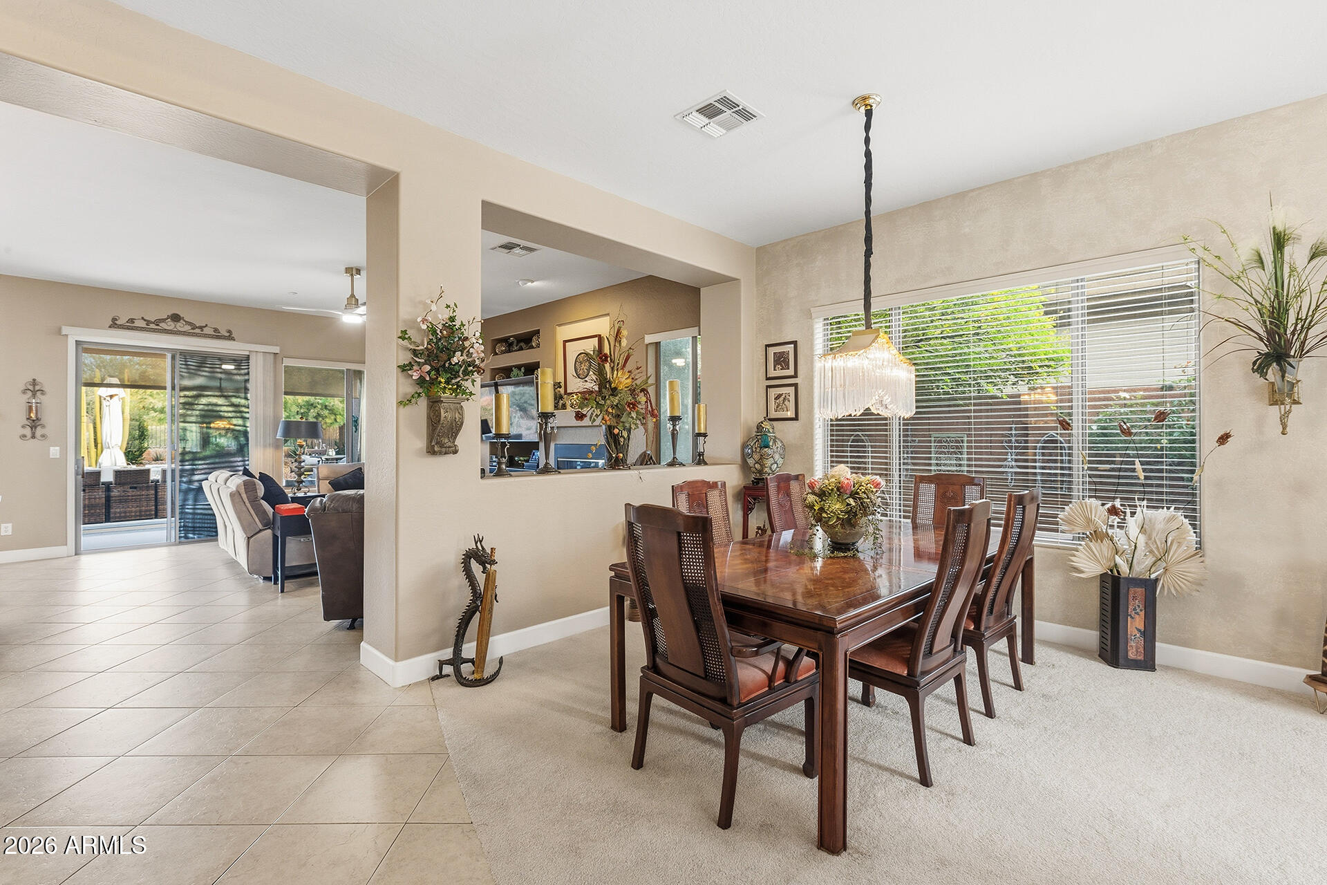 41712 North Golf Crest Road Anthem, AZ 85086 - Photo 13 of 39 a view of a dining room and livingroom with furniture wooden floor a chandelier