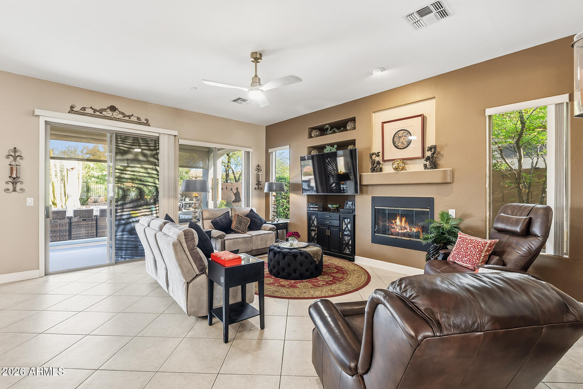 41712 North Golf Crest Road Anthem, AZ 85086 - Photo 14 of 39 a living room with furniture and a fireplace