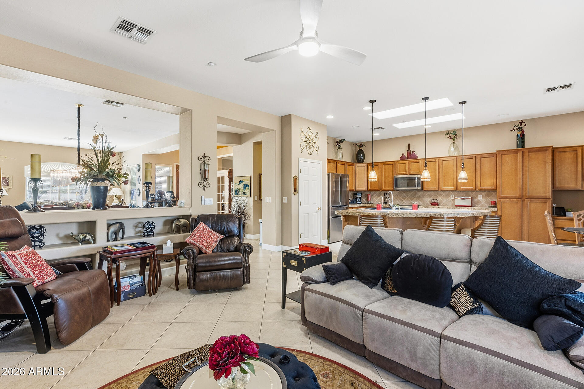 41712 North Golf Crest Road Anthem, AZ 85086 - Photo 15 of 39 a living room with furniture kitchen view and a chandelier