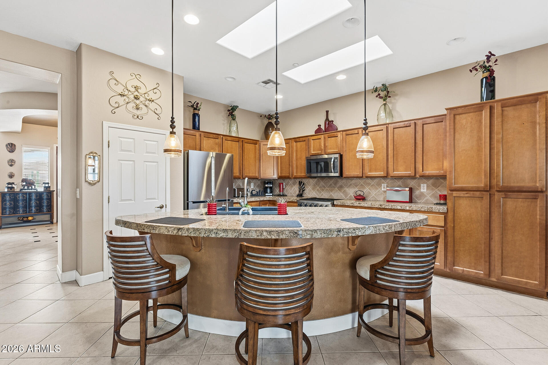 41712 North Golf Crest Road Anthem, AZ 85086 - Photo 17 of 39 a kitchen with stainless steel appliances granite countertop a sink and a refrigerator