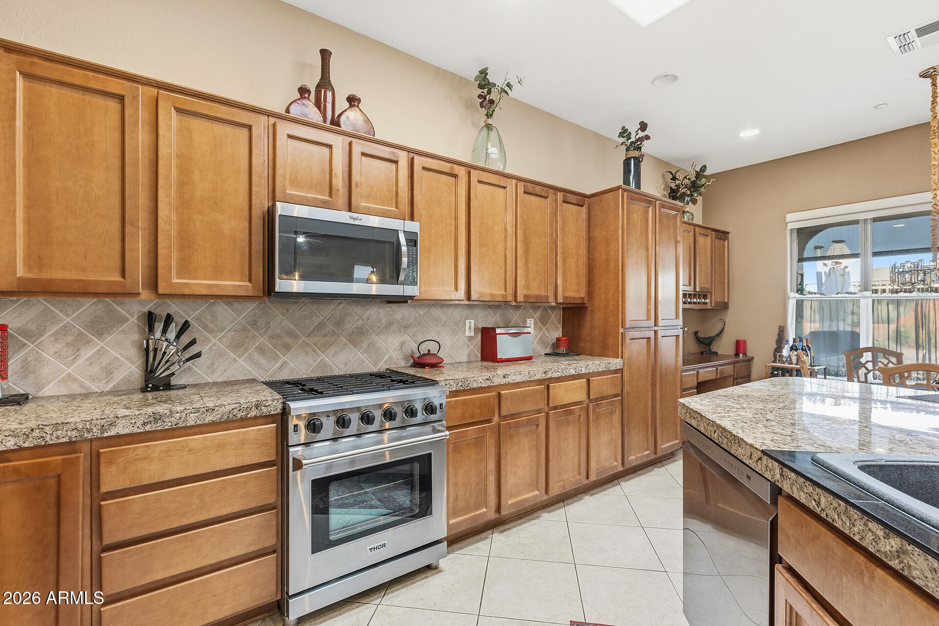 41712 North Golf Crest Road Anthem, AZ 85086 - Photo 20 of 39 a kitchen with stainless steel appliances granite countertop a sink stove and cabinets