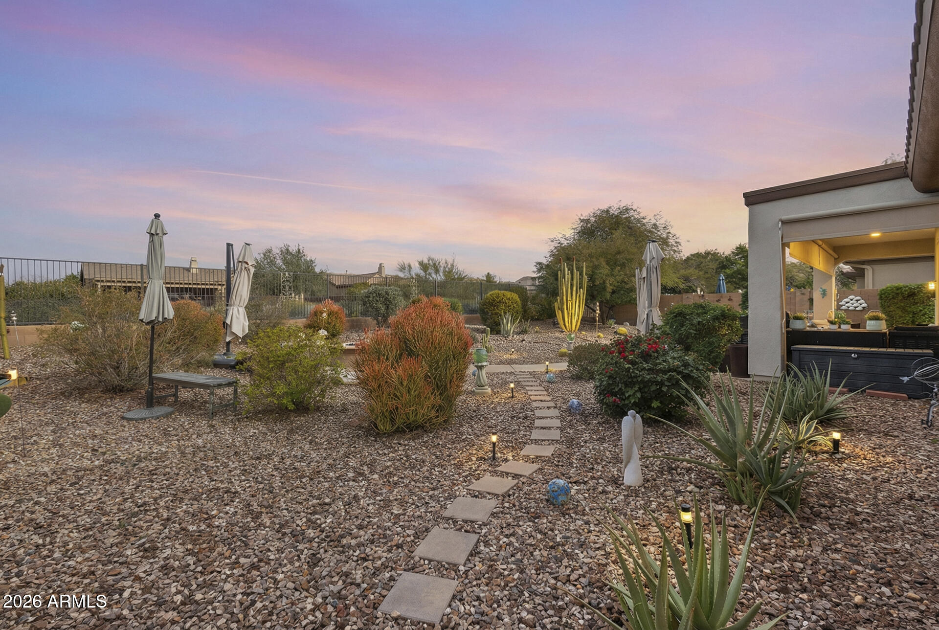 41712 North Golf Crest Road Anthem, AZ 85086 - Photo 25 of 39 a view of a yard with plants and a bench